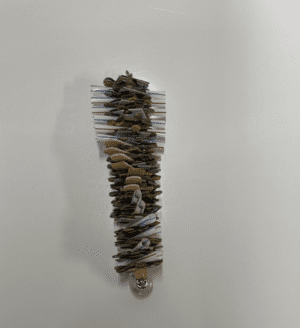A stack of Puzzling rocks on a white wall.